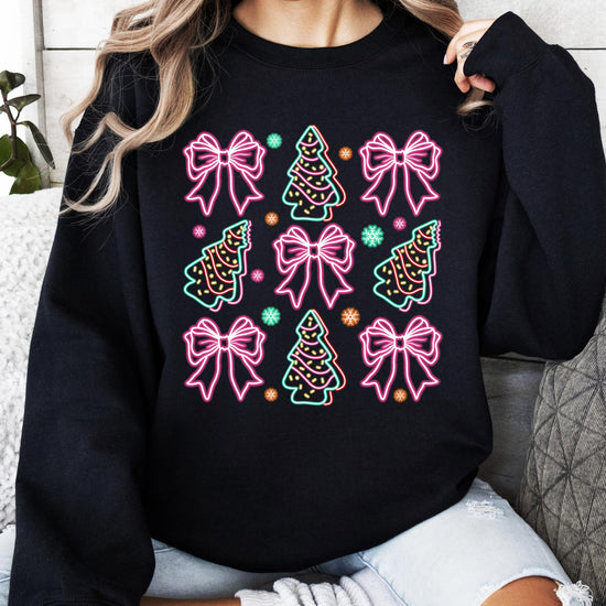 Front view of neon holiday graphic sweatshirt featuring colorful bows and Christmas trees on black fabric