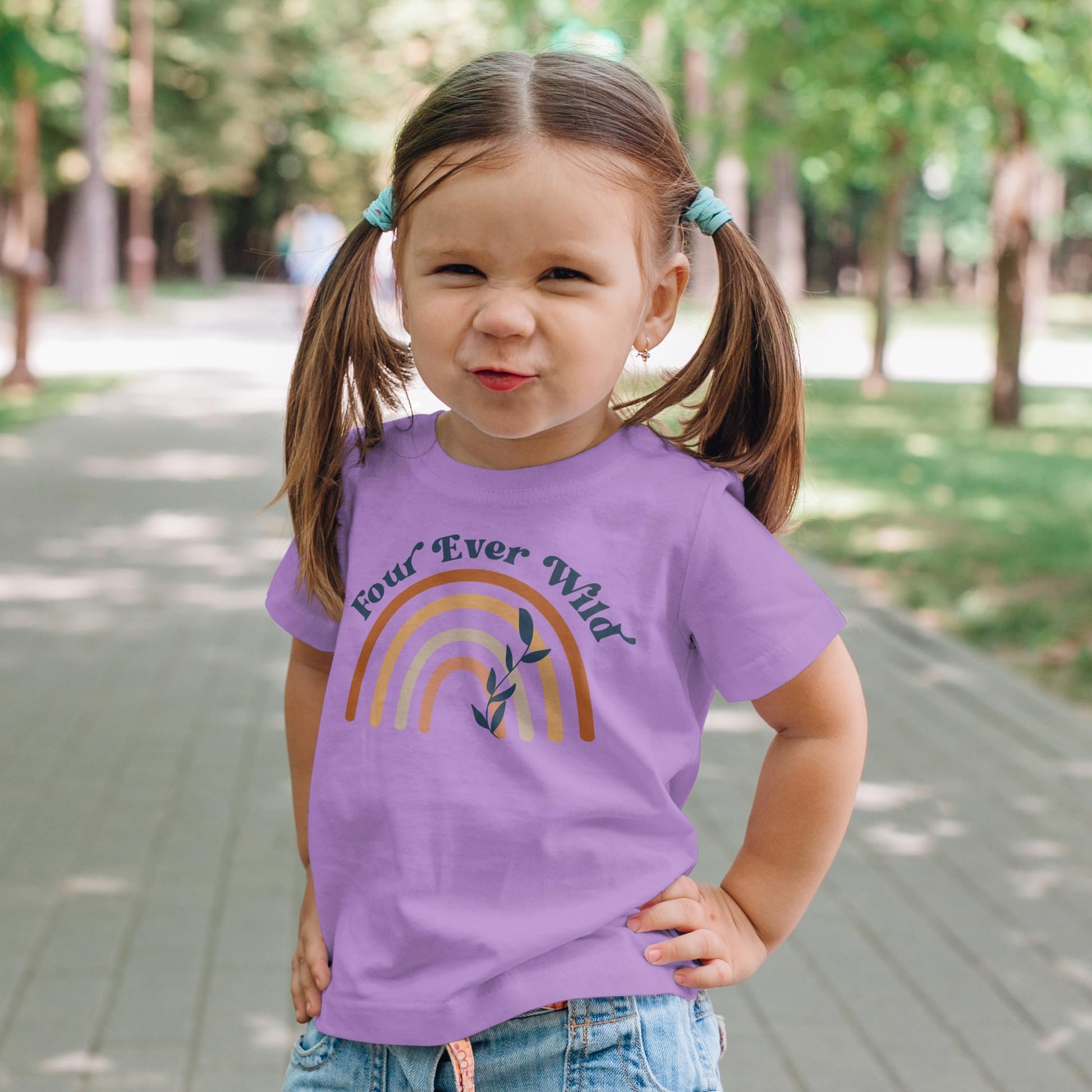 Flat lay of purple Four Ever Wild 4th birthday shirt for baby toddler and youth girls