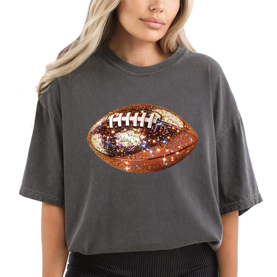 Close-up of glitter football graphic print on women's oversized tee