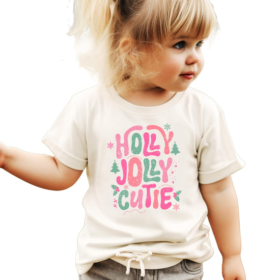 Detail shot of festive holiday graphic tee for girls featuring snowflakes and Christmas tree design elements