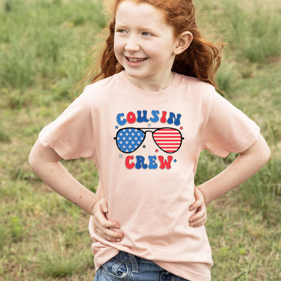 Full front view of Cousin Crew patriotic youth tee with red white blue sunglasses design