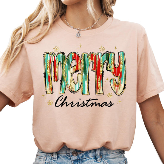 Detail shot of soft peach fabric with colorful watercolor Merry Christmas design