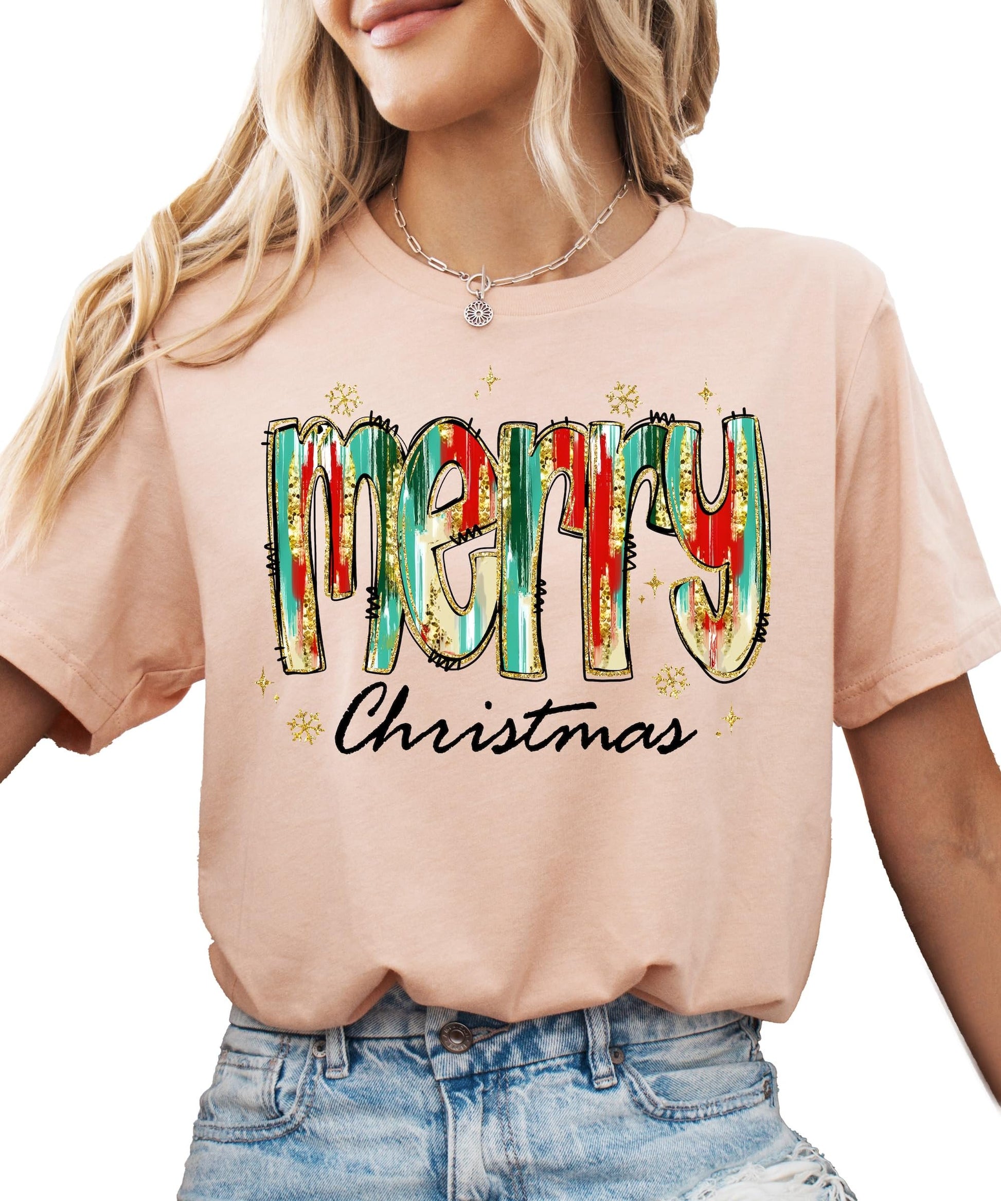 Detail shot of soft peach fabric with colorful watercolor Merry Christmas design