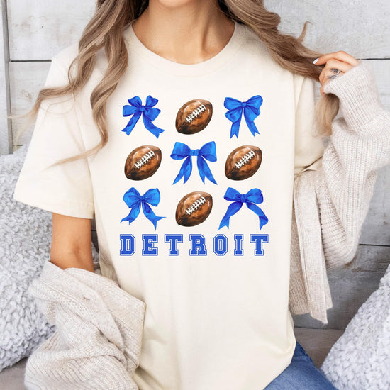 Detroit football shirt for women laid flat showing full girly bows and footballs graphic