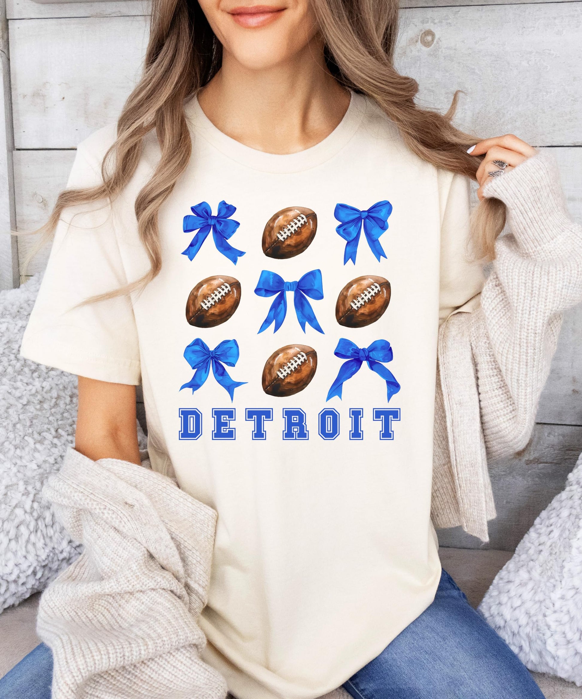 Detroit football shirt for women laid flat showing full girly bows and footballs graphic