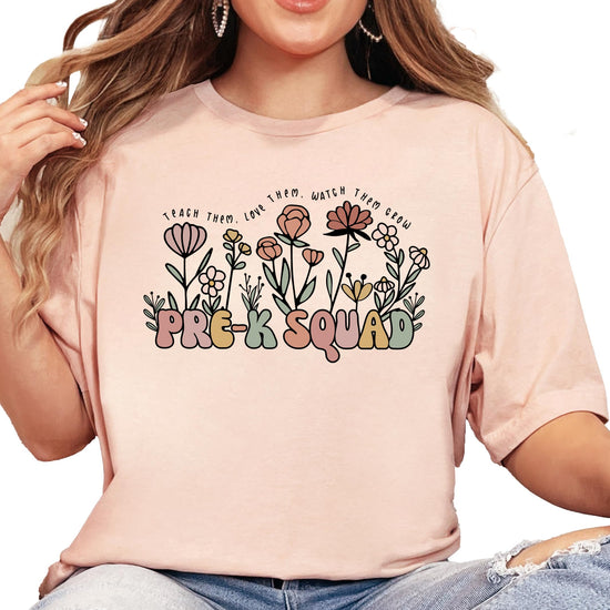 Back or side view of Pre-K Squad women's graphic teacher t-shirt in peach