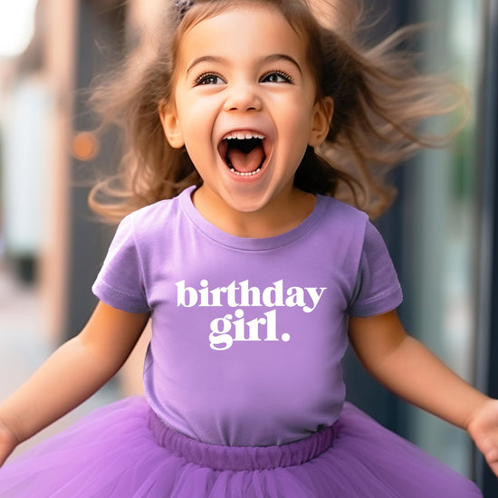 Toddler girl wearing purple Birthday Girl Period graphic shirt from Olive Loves Apple