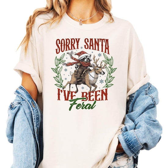 Seafoam green funny holiday tee for women and teens featuring raccoon reindeer Christmas graphic