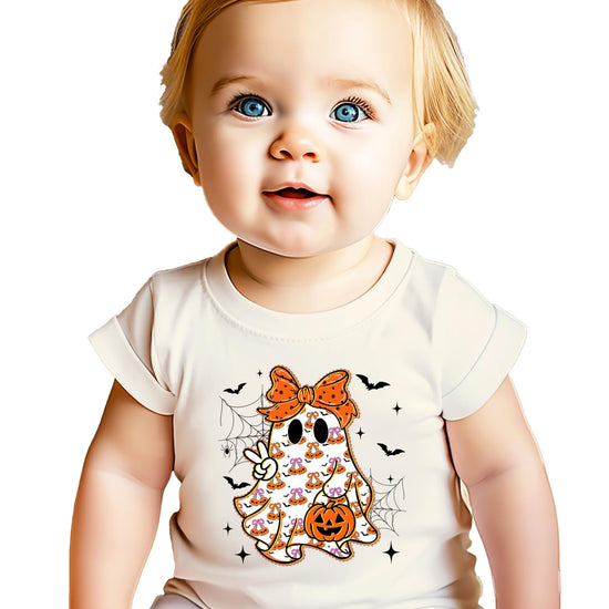 Flat lay of natural kids Halloween tee featuring a spooky cute ghost with an orange bow
