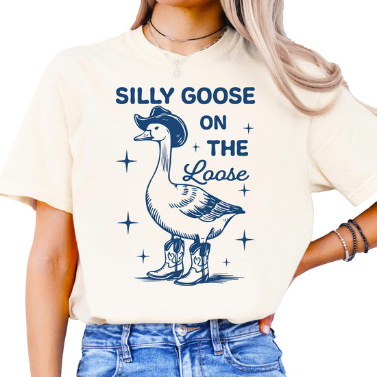 Silly Goose on the Loose ivory oversized t-shirt with cartoon goose in cowboy boots and hat