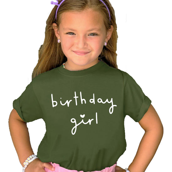 Flat lay of military green kids birthday shirt with white heart Birthday Girl design