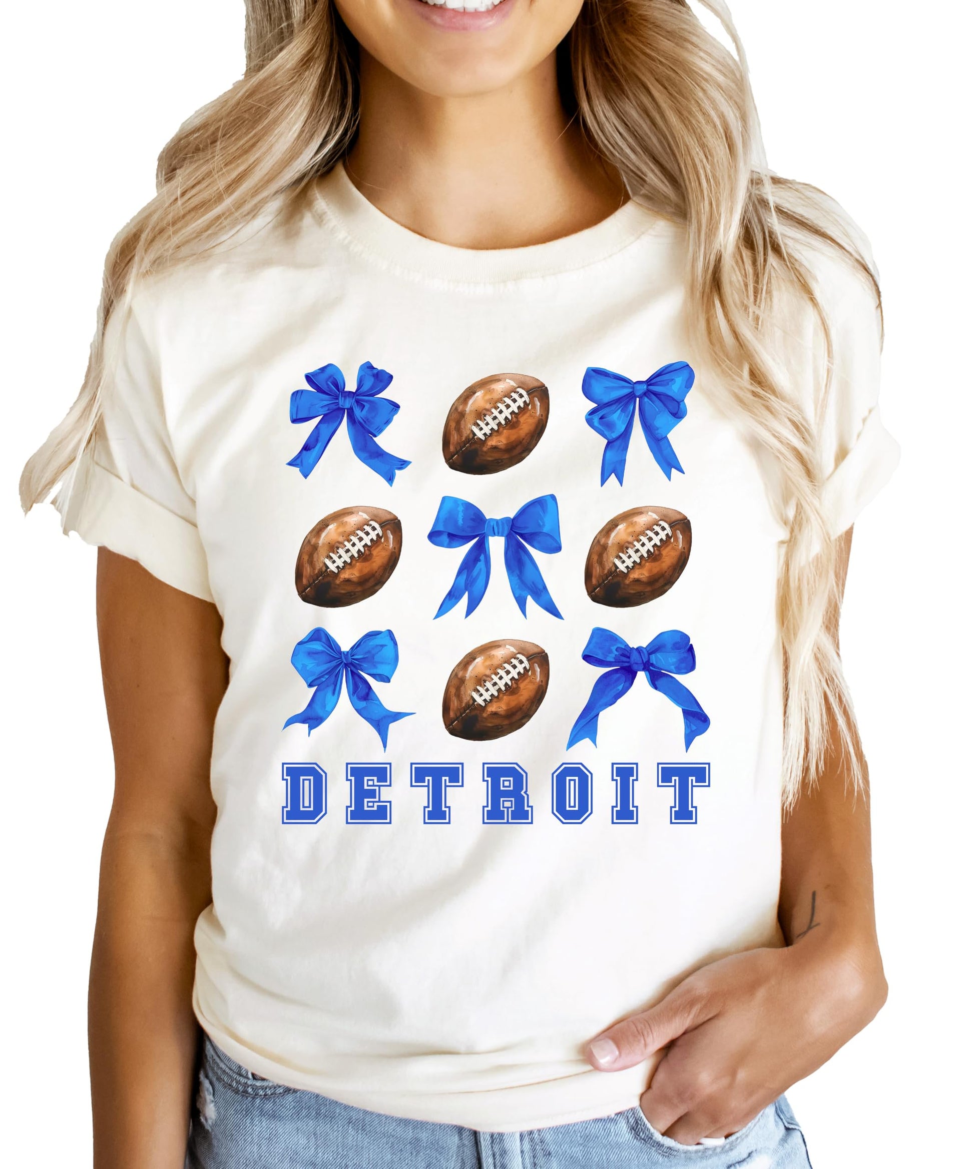Women's natural color Detroit football graphic tee with girly footballs and coquette blue bows design