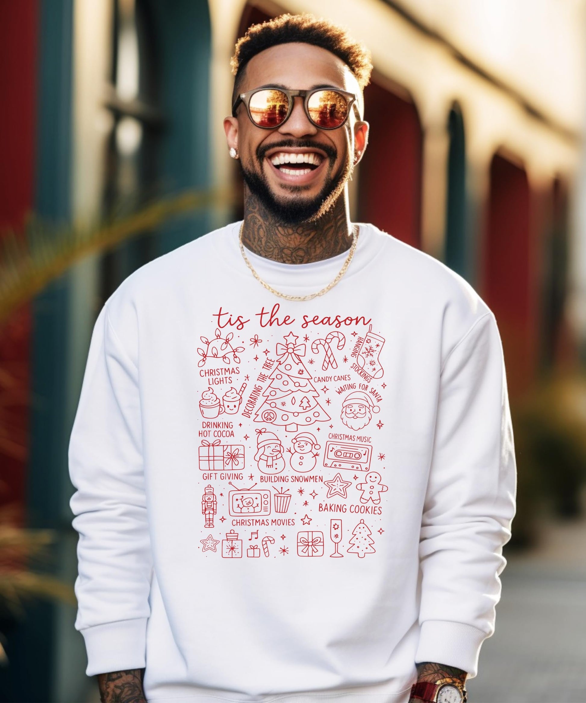 Close-up of 'Tis the Season holiday graphic print on white sweatshirt showing print quality