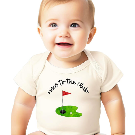 Front view of New to the Club golf bodysuit on a flat lay showing hand-illustrated golf design