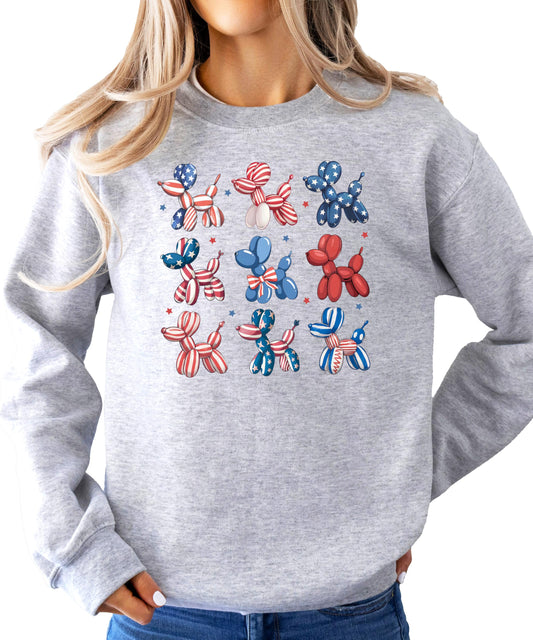 Close-up of red white and blue balloon dog graphic print on white sweatshirt