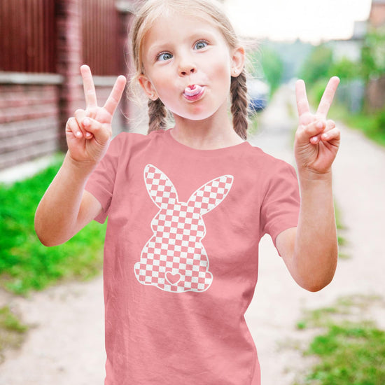 Close-up of bunny checkered graphic print on peach girls Easter tee