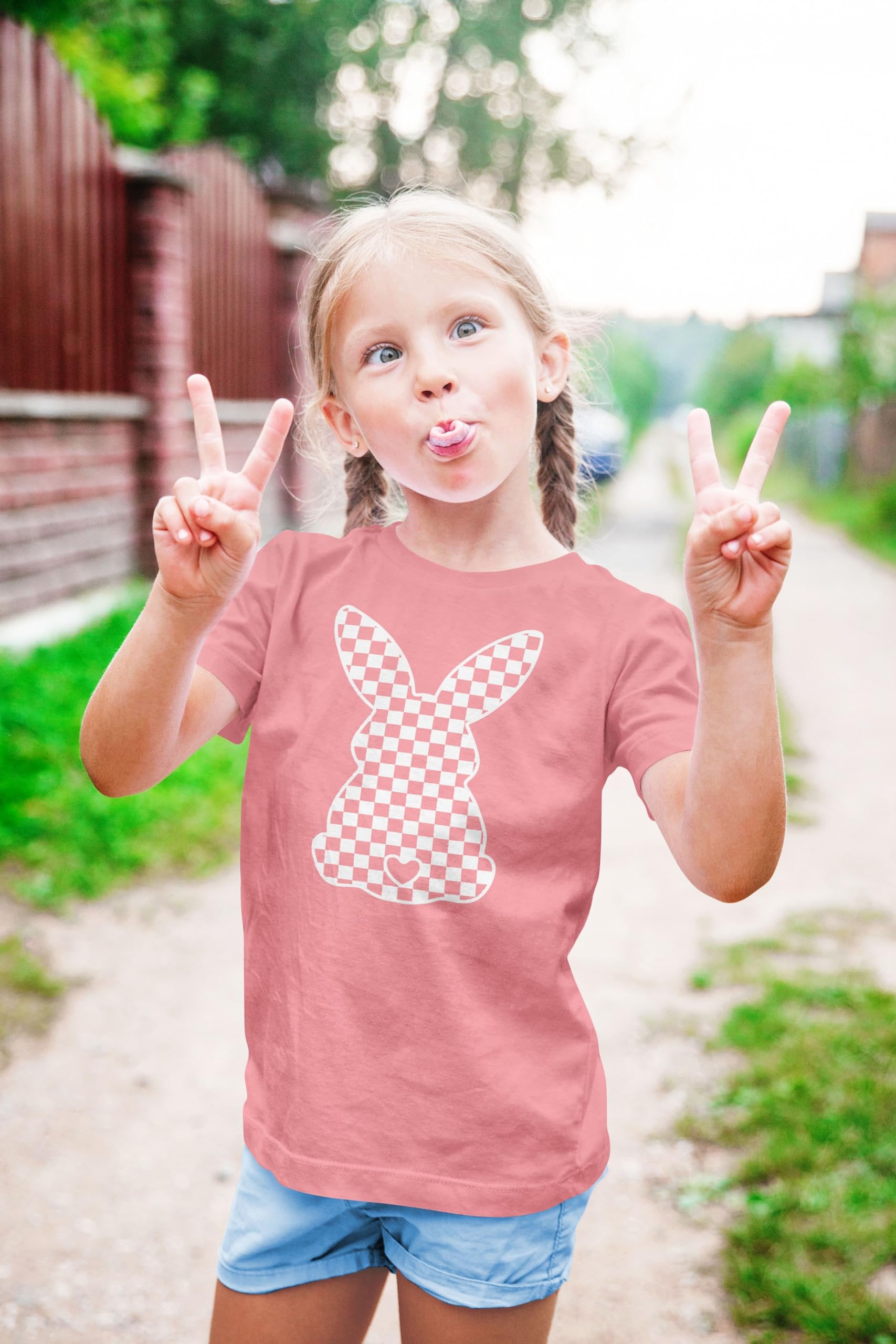 Close-up of bunny checkered graphic print on peach girls Easter tee
