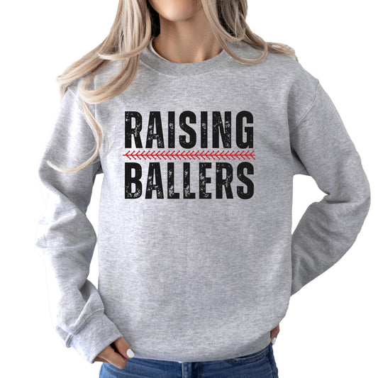Close-up of Raising Ballers print on a gray women's sweatshirt
