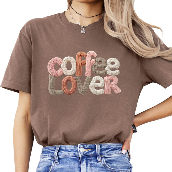 Close-up of coffee lover ink-printed graphic on ivory women's tee