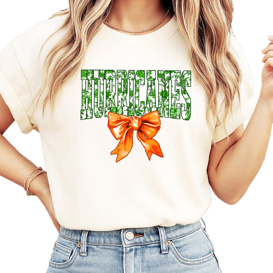 Full layout flat lay of Hurricanes green floral orange bow graphic tee for women and teens