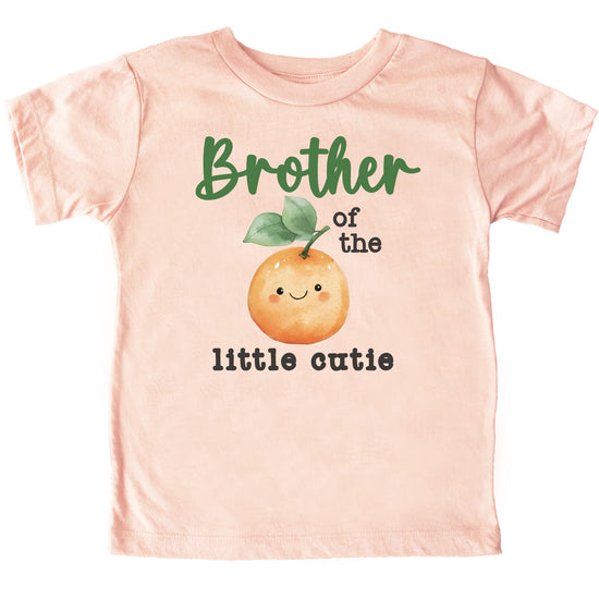 Matching family birthday shirts with One Little Cutie orange citrus theme, group flat lay