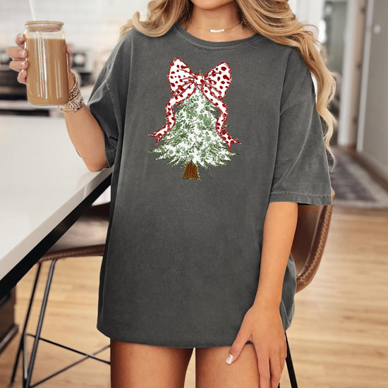 Detail shot of red polka dot coquette bow topping the faux glitter floral Christmas tree shirt design