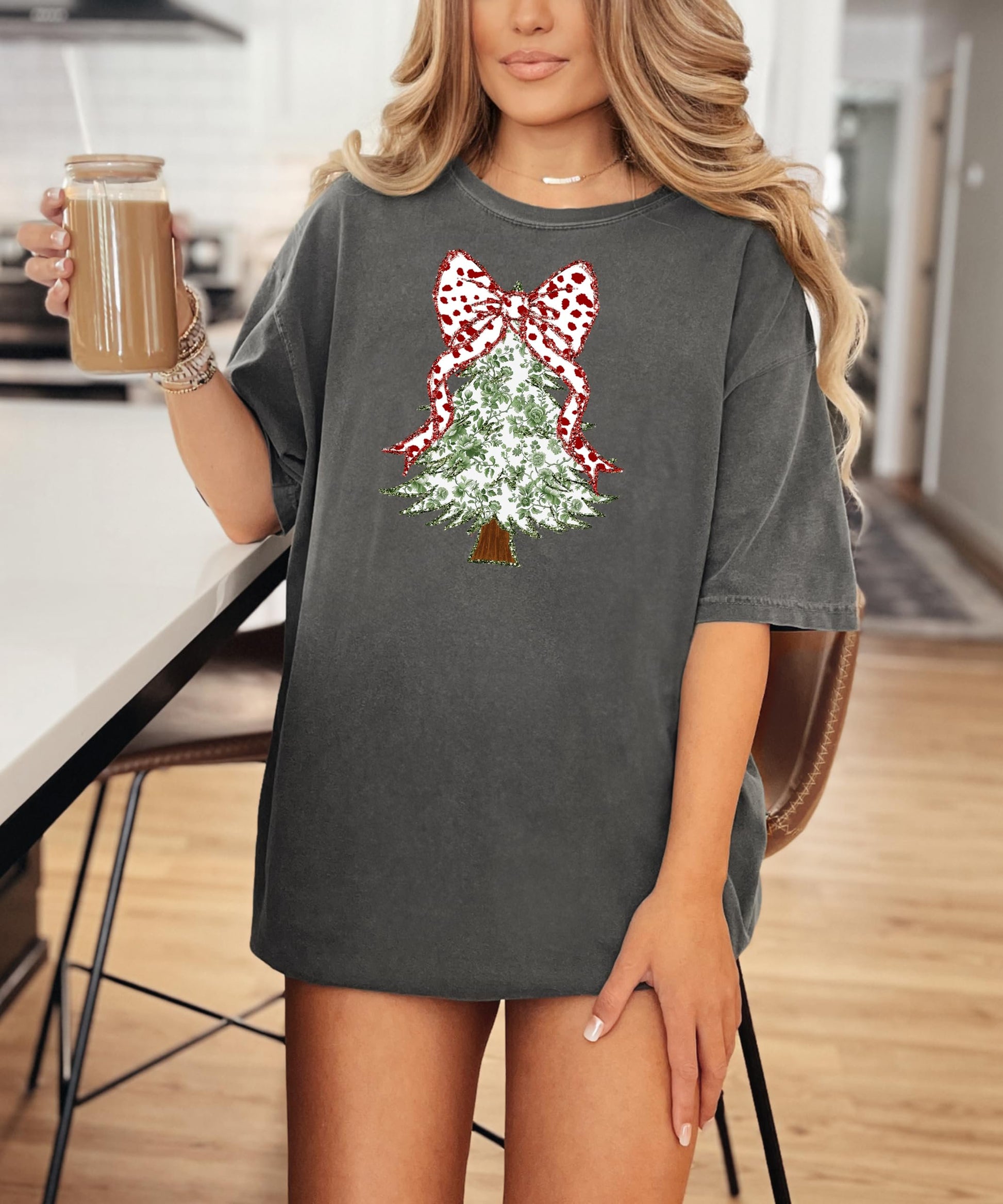 Detail shot of red polka dot coquette bow topping the faux glitter floral Christmas tree shirt design