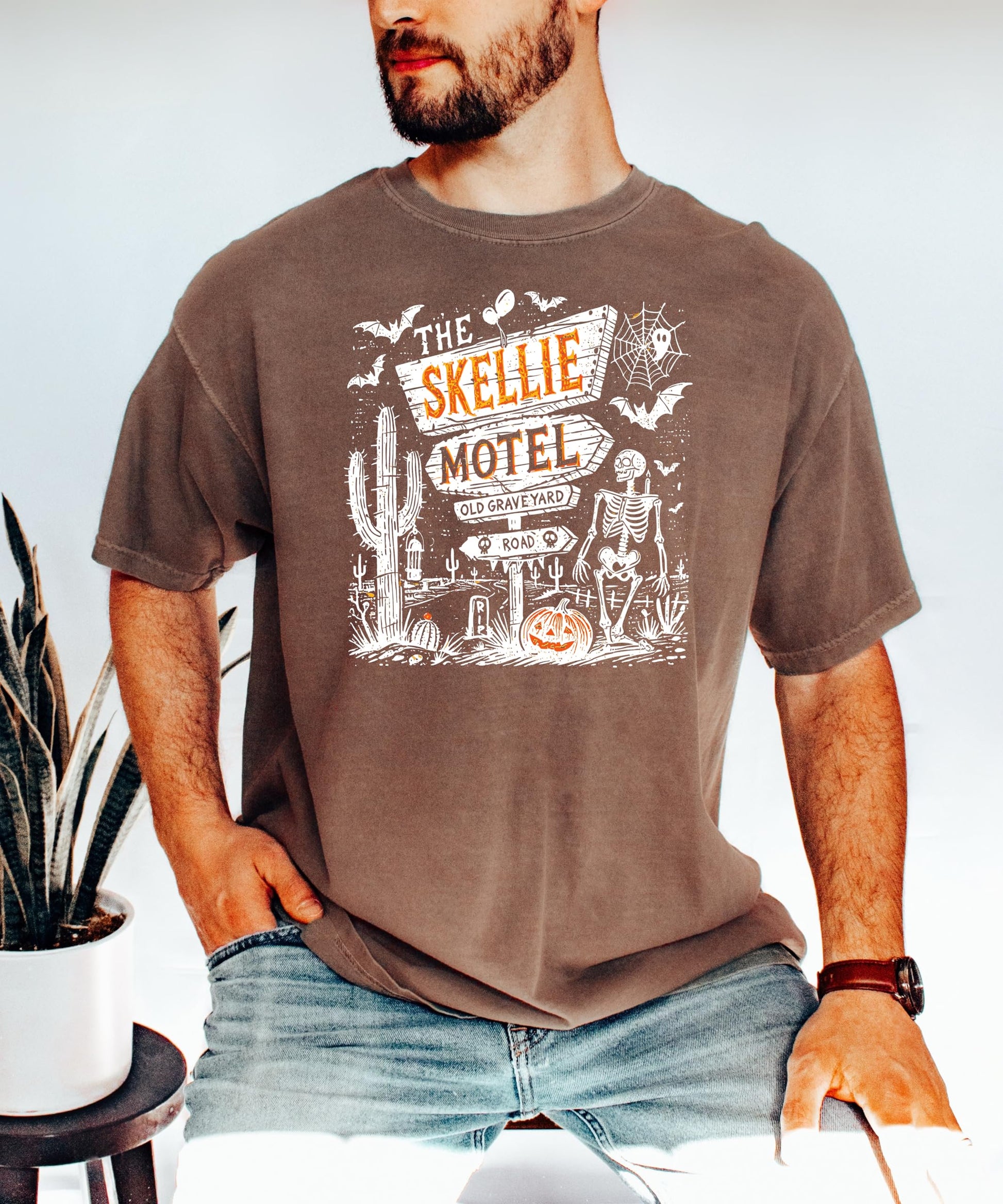 Flat lay of Skellie Motel Halloween unisex graphic tee showcasing full design and seafoam colorway