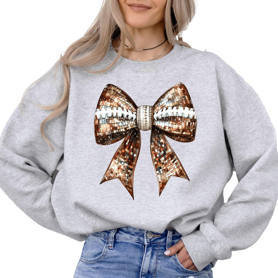 Women's gray sweatshirt with disco football and coquette bow graphic by Olive Loves Apple