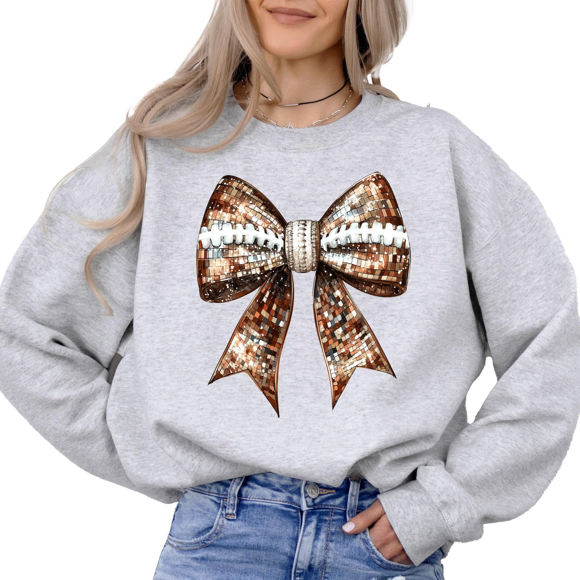 Women's gray sweatshirt with disco football and coquette bow graphic by Olive Loves Apple