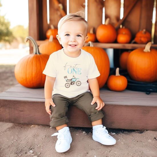 Toddler wearing Fast One dirt bike birthday shirt styled for a first birthday party