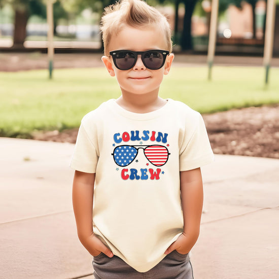 Youth model wearing Cousin Crew patriotic shirt in casual summer setting