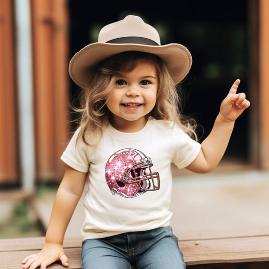 Close-up of faux glitter football helmet print detail on girls graphic tee