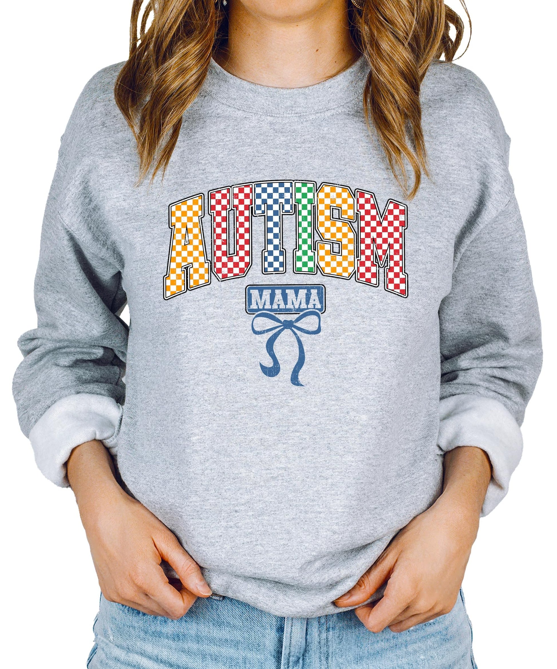 Close-up of bold multicolor checkered Autism Mama print on white sweatshirt