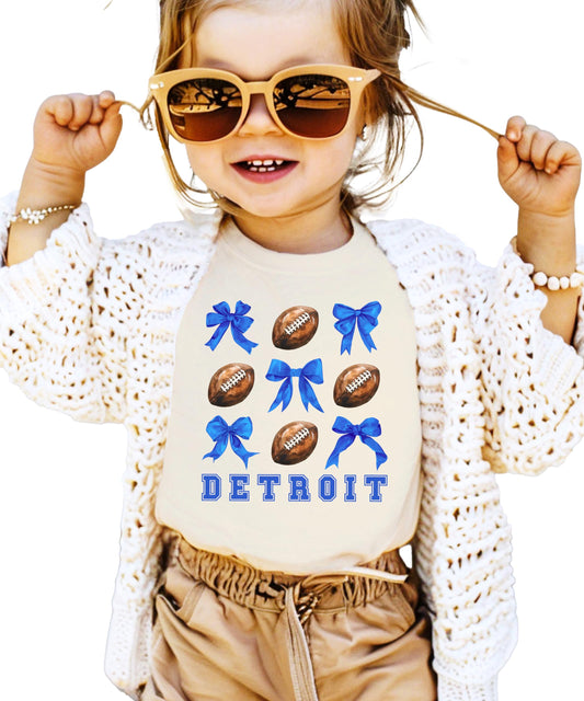 Model wearing Detroit football coquette bow tee in natural color, casual game day style