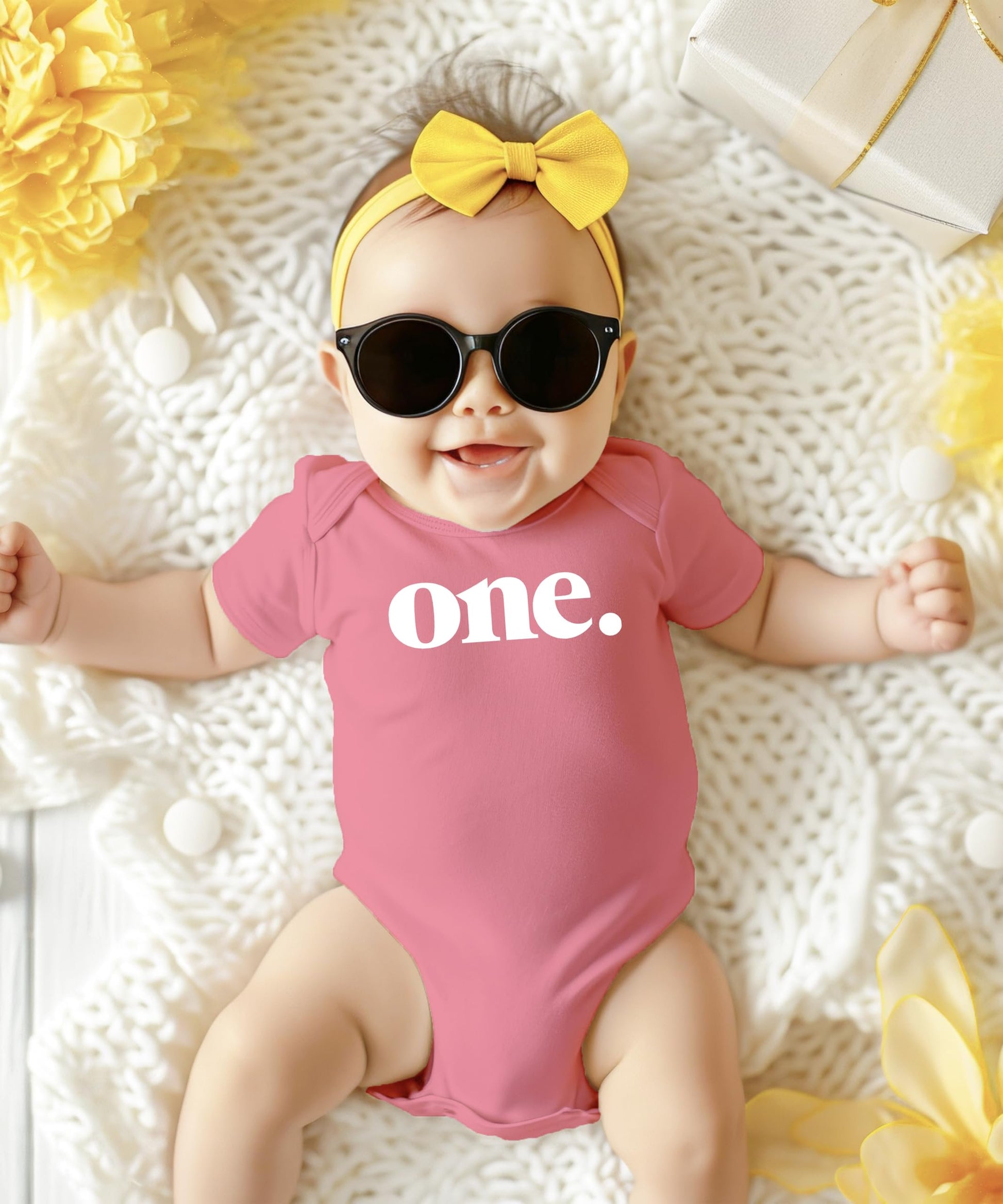 Detail shot of white Bold One print on mauve bodysuit for baby 1st birthday party outfit