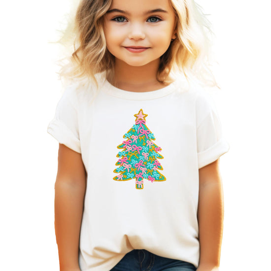 Kids natural tee with ink-printed Christmas tree graphic featuring pink bow ornaments and gold star topper