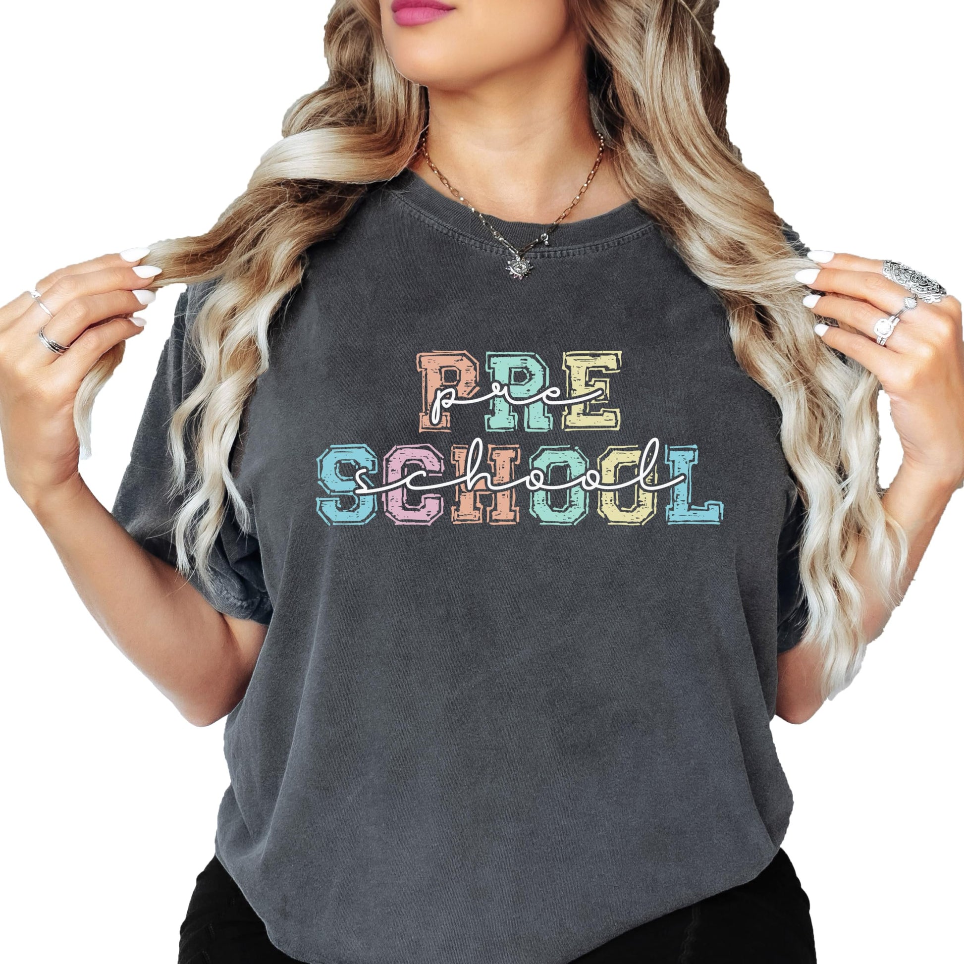 Close-up of bold multicolor preschool teacher graphic print on a soft women's t-shirt