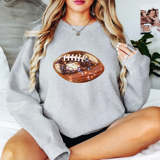 Side or styled view of women's white glitter football pullover sweatshirt