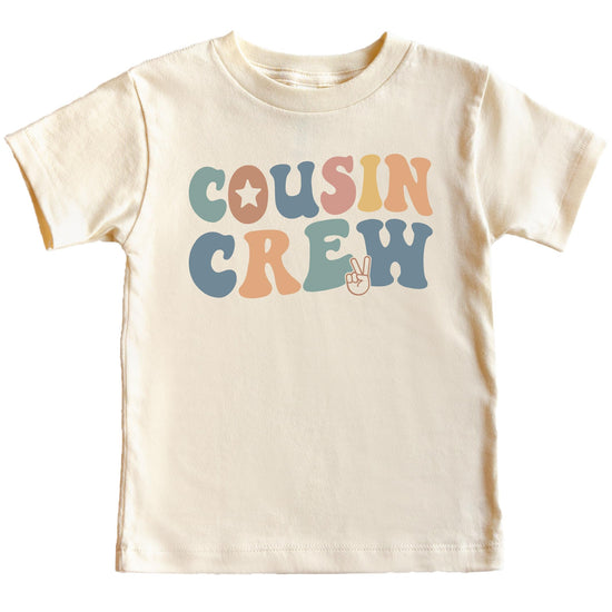 Flat lay of natural Cousin Crew youth tee showing full design and fit