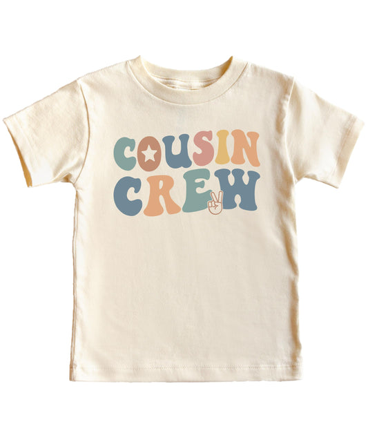 Flat lay of natural Cousin Crew youth tee showing full design and fit