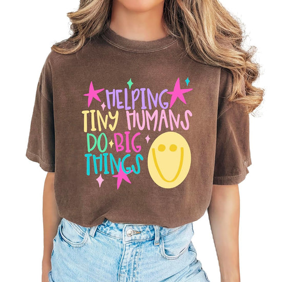 Lifestyle detail shot of Helping Tiny Humans Do Big Things early childhood educator graphic tee printed in Mesa, Arizona