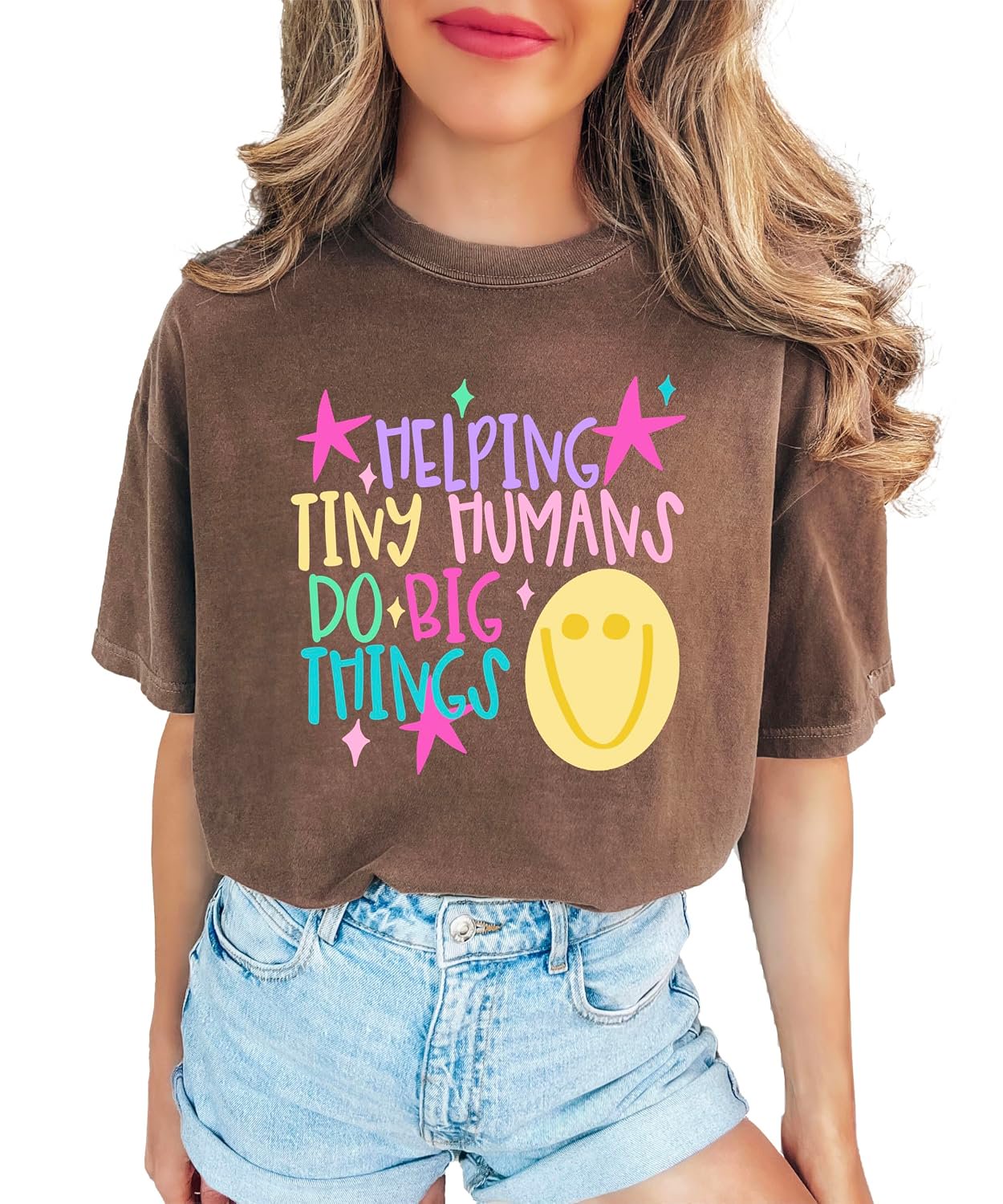 Lifestyle detail shot of Helping Tiny Humans Do Big Things early childhood educator graphic tee printed in Mesa, Arizona