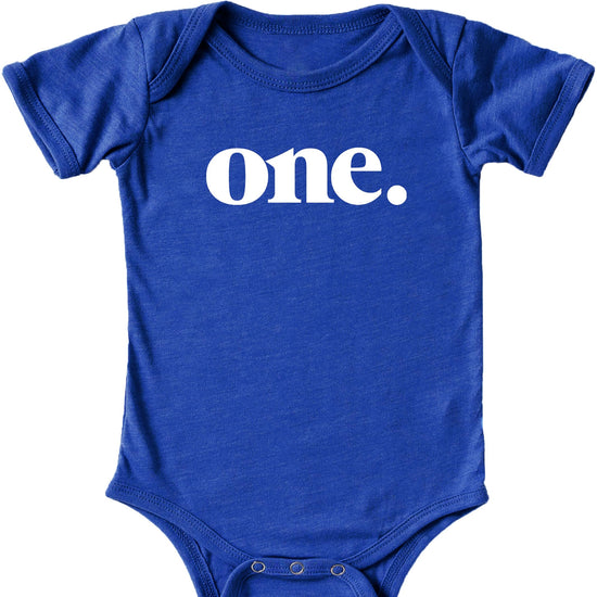Close-up of Bold One graphic print on mauve baby bodysuit for first birthday