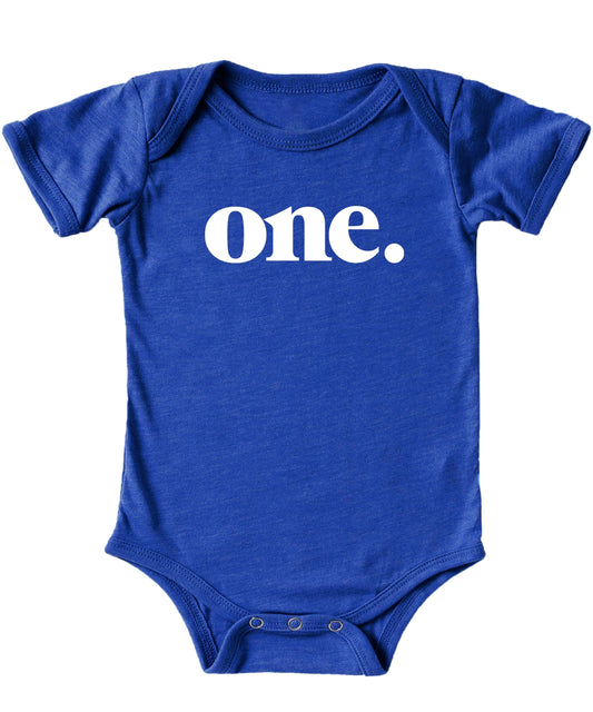Close-up of Bold One graphic print on mauve baby bodysuit for first birthday