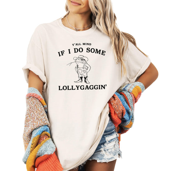 Close-up view of funny farmer toad graphic with lollygaggin text on seafoam shirt