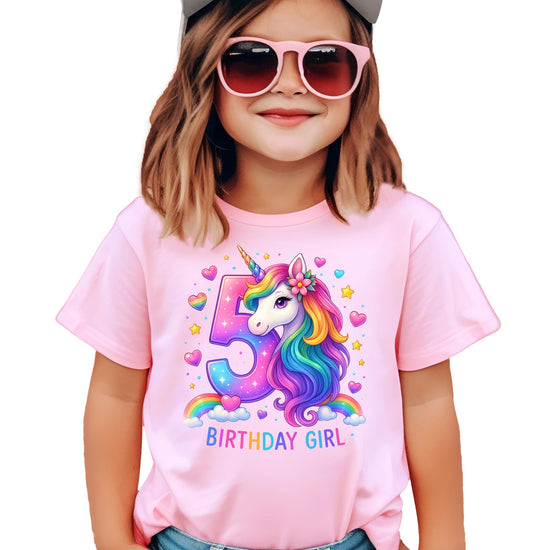 Detail shot of ink-printed sparkling number 5 and rainbow unicorn on pink kids tee
