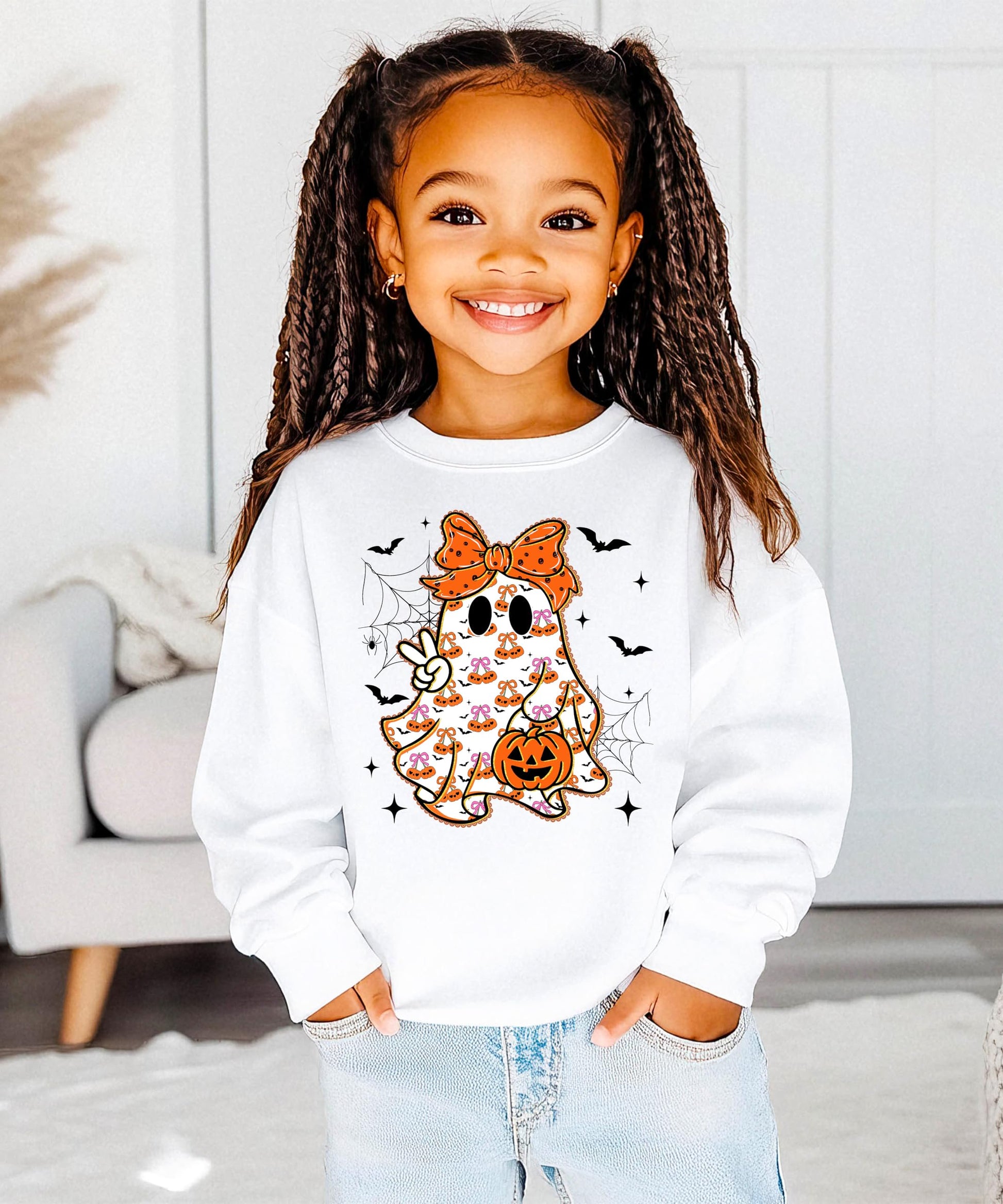 Flat lay of gray kids Halloween sweatshirt featuring cute ghost with orange bow design