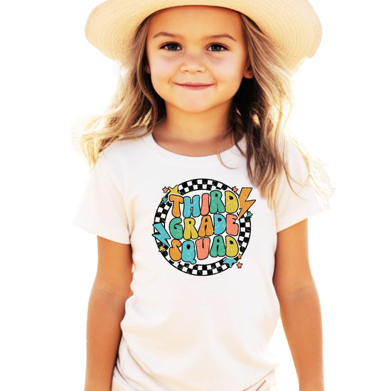 Front view of youth 3rd Grade Squad lightning graphic tee in natural tone on white background