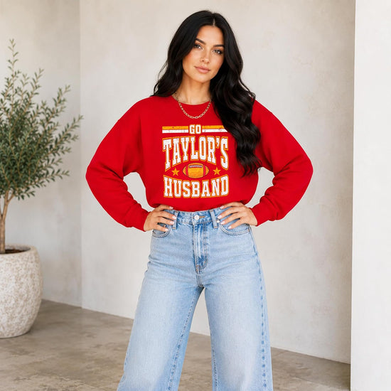 Flat lay of Go Taylor's Husband Swiftie football sweatshirt showing ribbed cuffs and hem detail